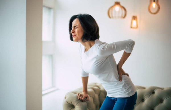 Woman Holding her back due to pain