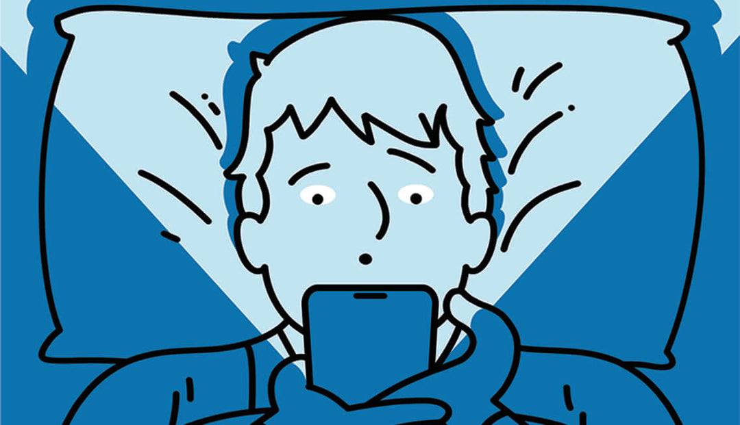 Person using their phone whilst in bed